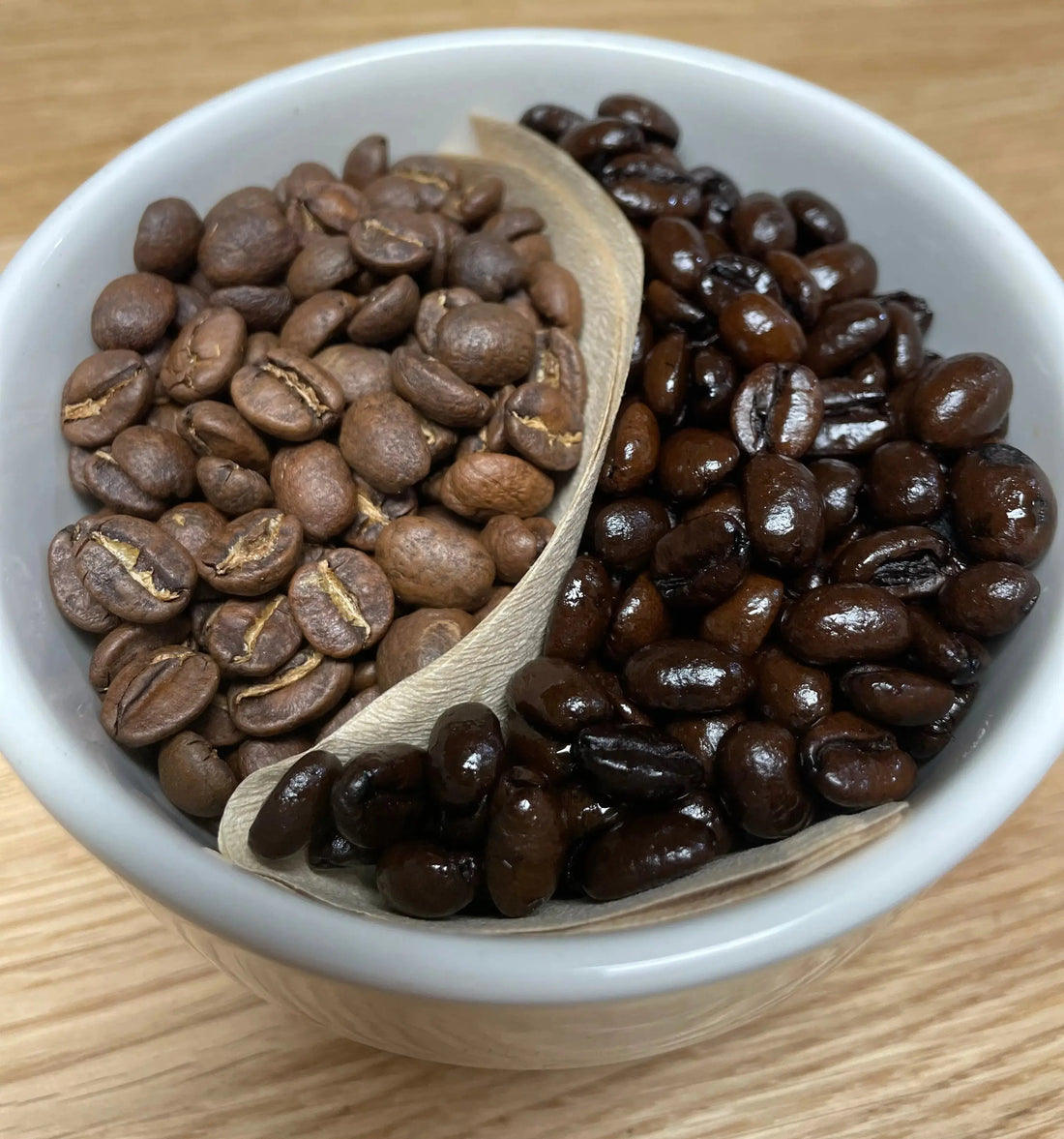 Image of Medium Roasted Coffee beans next to Dark Roasted coffee Beans