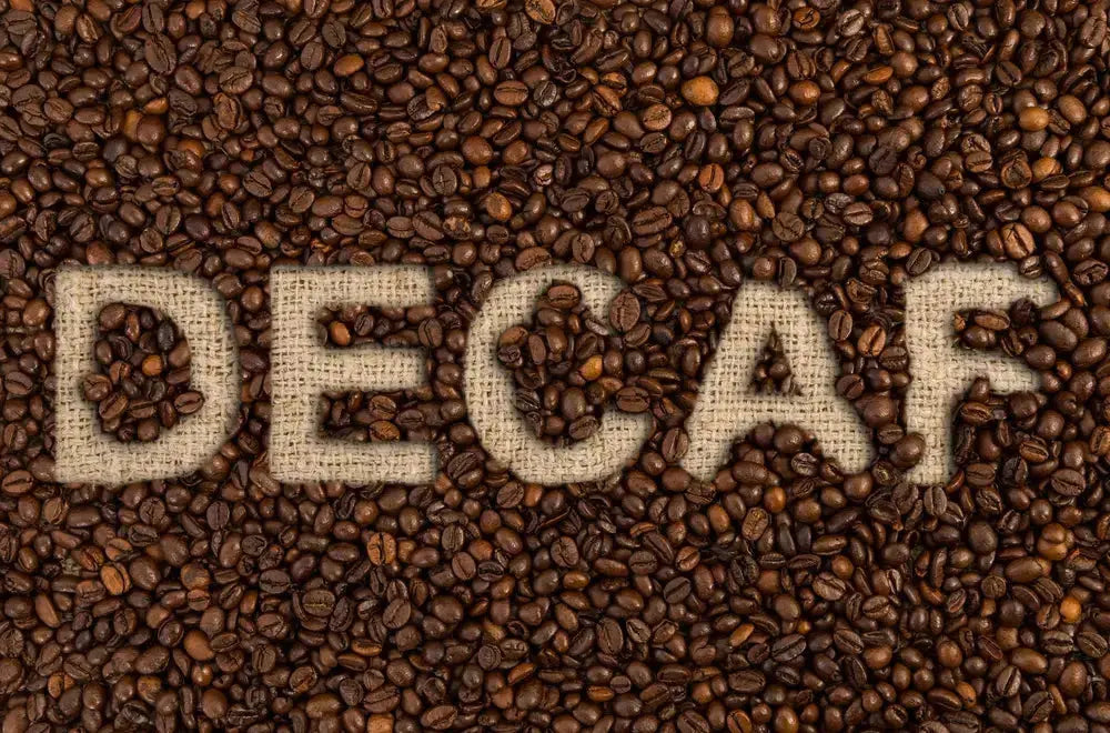 Roasted coffee beans with the word Decaf on top.
