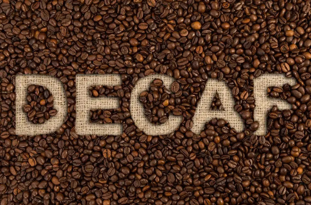 Roasted coffee beans with the word Decaf on top.