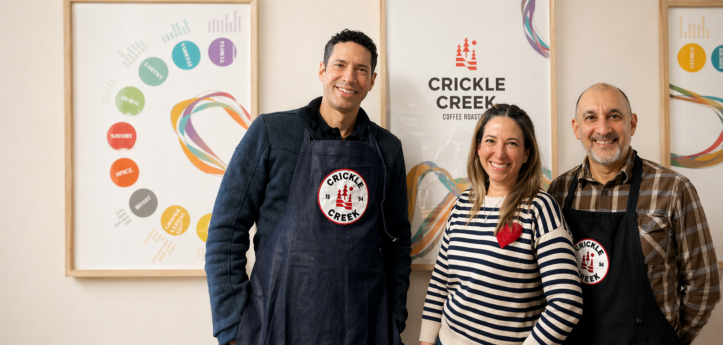 Three people standing together with Crickle Creek Coffee branding in the background